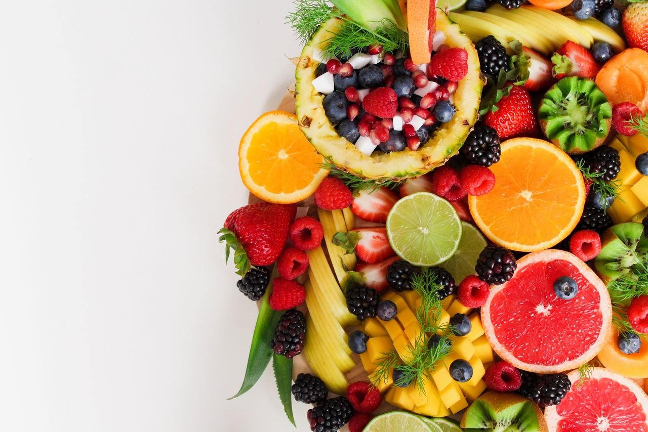 An assortment of fresh sliced fruits — kiwi, strawberries, citrus — for a colourful daily vitamin C intake